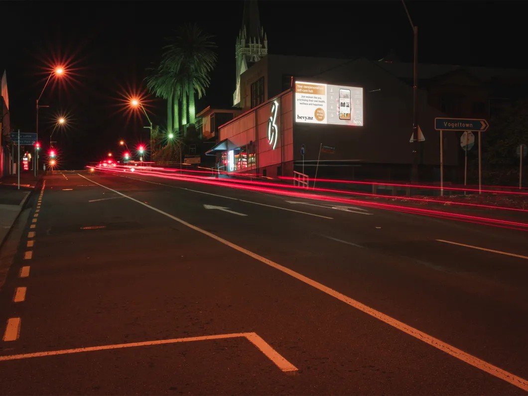 Night time photo of Digital billboard on the corner of Courtney & Carrington Streets.